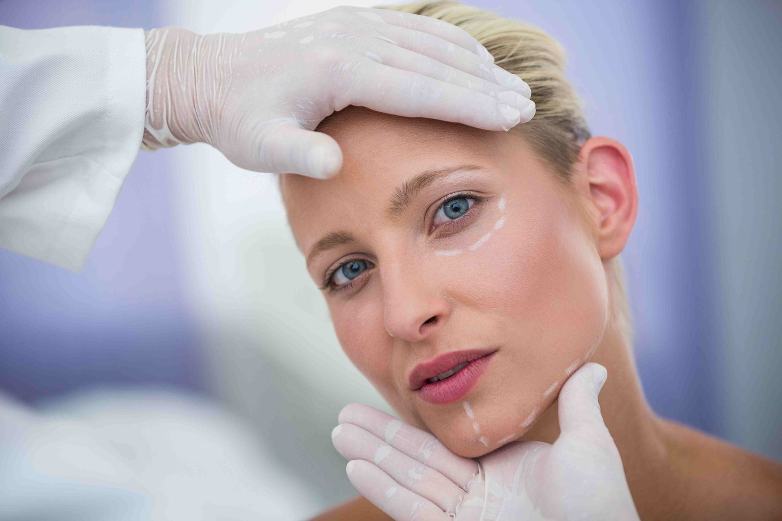 doctor examining female patients face cosmetic treatment 11zon